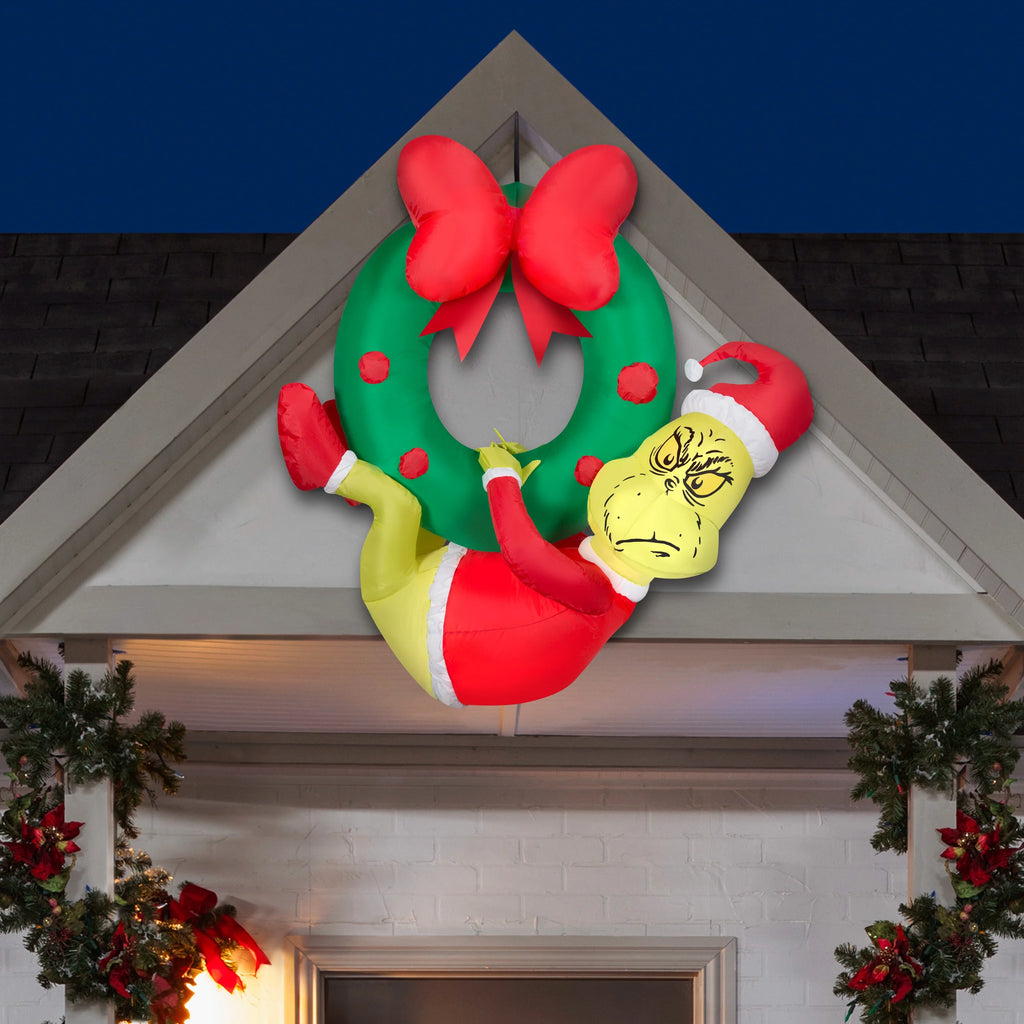 Green 4 ft Tall Inflatable Grinch Hanging from Wreath B303